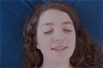 Reiki client's face with eyes closed and mouth open, talking.